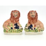 A pair of 19th Century Staffordshire pottery flatback lion and Napoleon chimney figures, circa