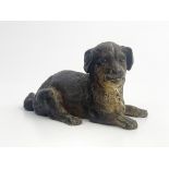 A late 19th Century Austrian cold painted bronze model of a recumbent puppy, impressed lozenge