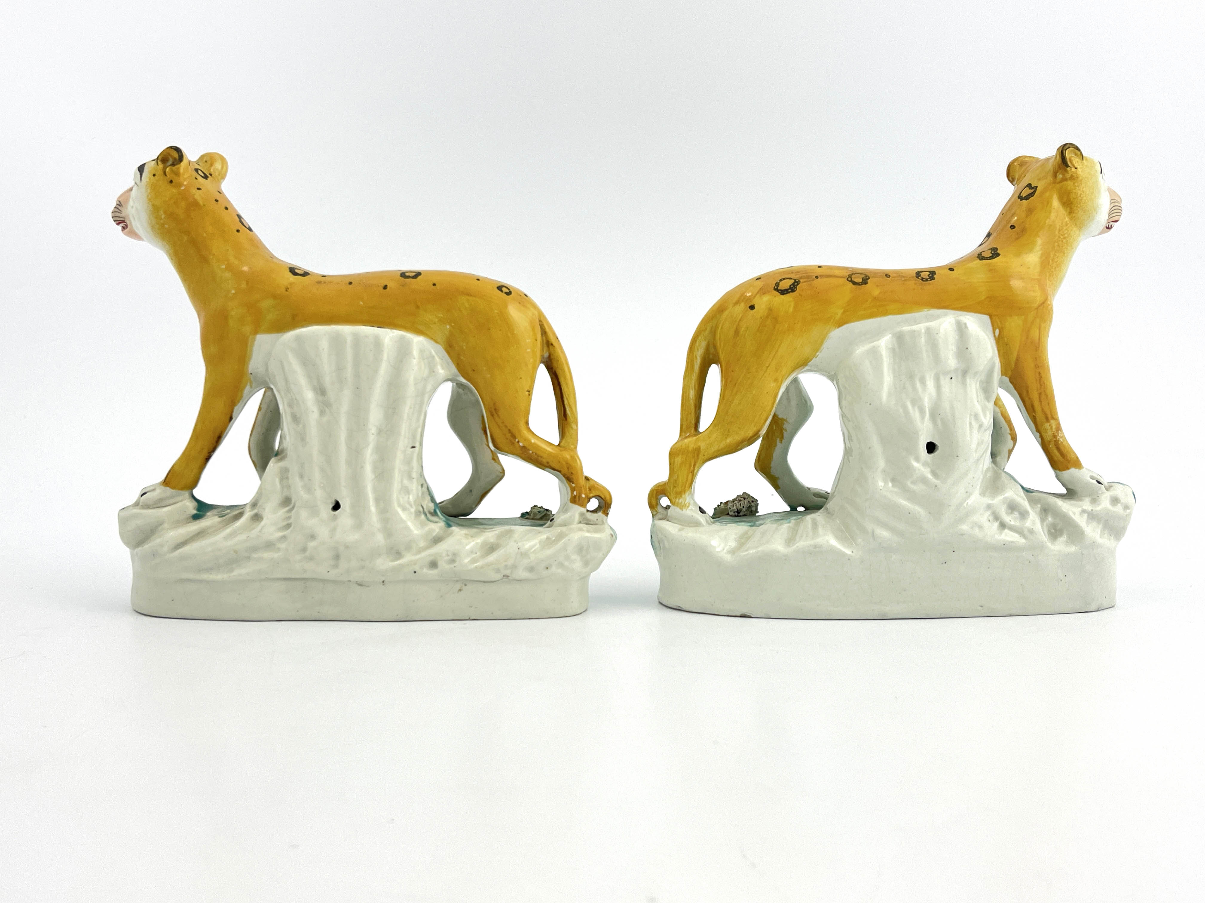 A rare pair of 19th Century Staffordshire pottery leopards, modelled strolling and decorated in - Image 2 of 7