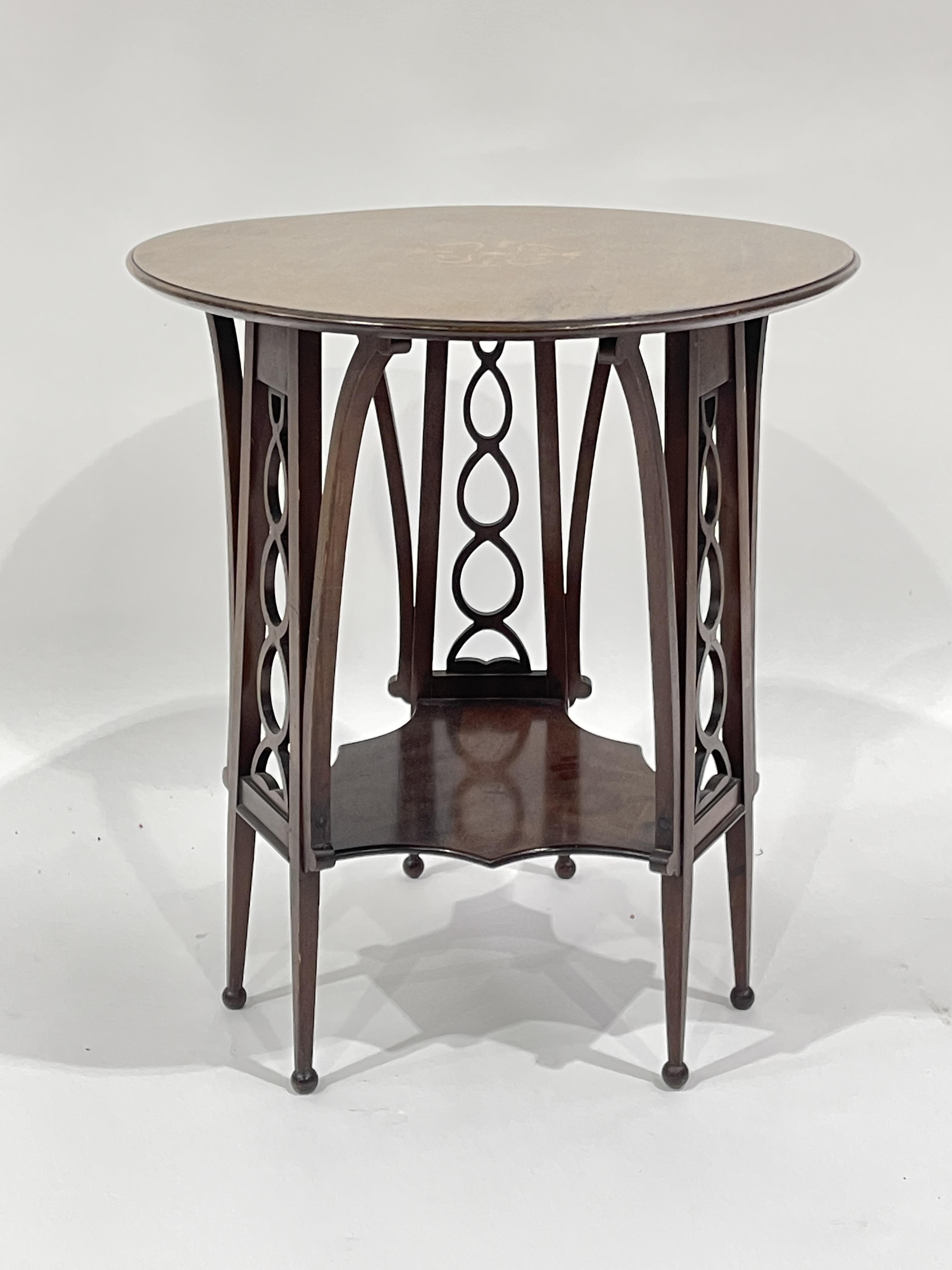 An Edwardian mahogany Art Nouveau occasional table, circa 1905, circular marquetry inlaid top,