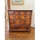 A George I walnut crossbanded chest of drawers, circa 1720 and later, rectangular oak top above