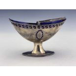 A George III silver sugar basket, London 1787, pierced boat form with beaded swing handle, on oval