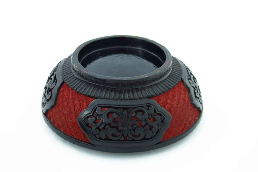 A Chinese red and black lacquer circular covered vessel, carved in high relief with two figures in a - Image 5 of 5