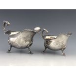 A pair of George V graduating silver sauce boats, Walker and Hall, Sheffield, 1916, wavy rims,