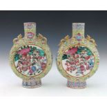 A pair of 19th Century Chinese moonflasks, zoomorphic gilt twin handles, famille rose decorated with