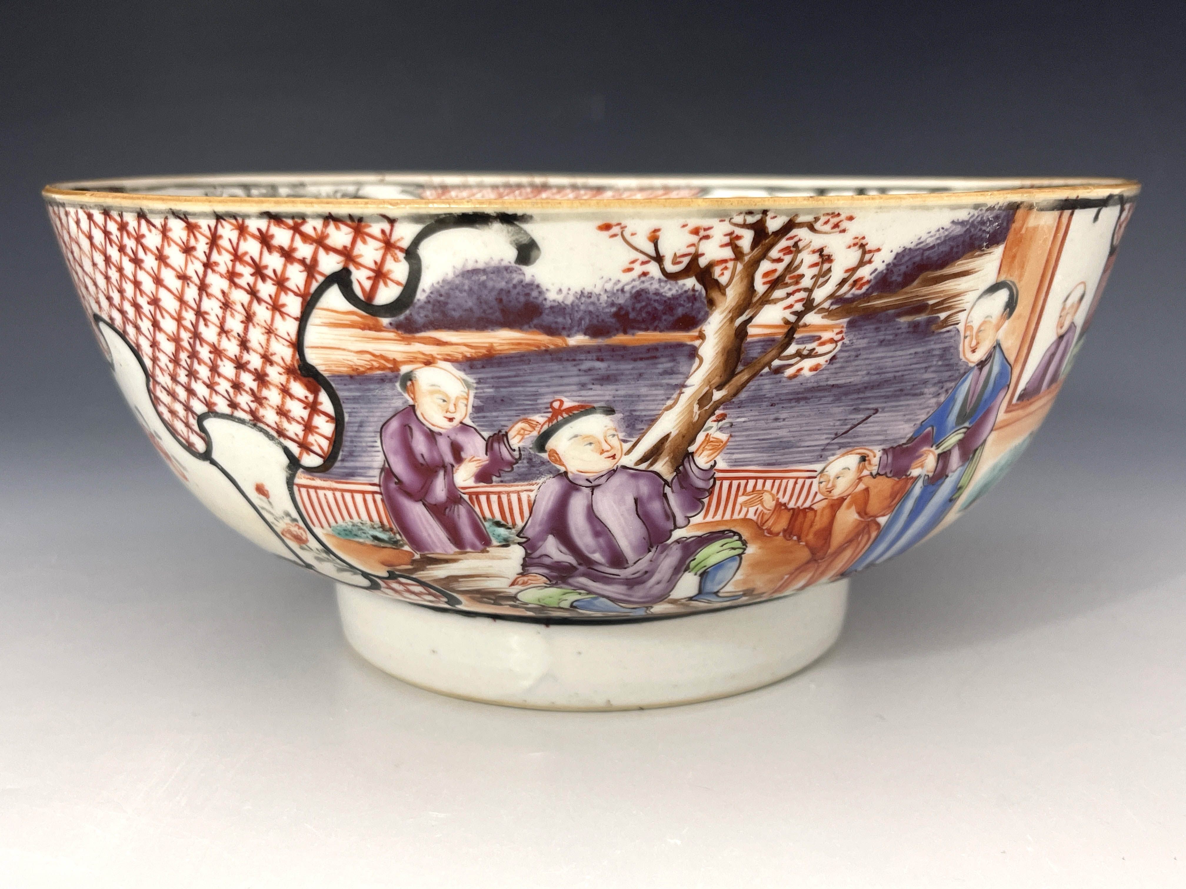 A Chinese famille rose bowl, late 18th Century, the frieze decorated with cartouche panels of