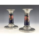 William Moorcroft for Liberty and Co., a pair of Tudric Arts and Crafts pewter mounted Pomegranate c