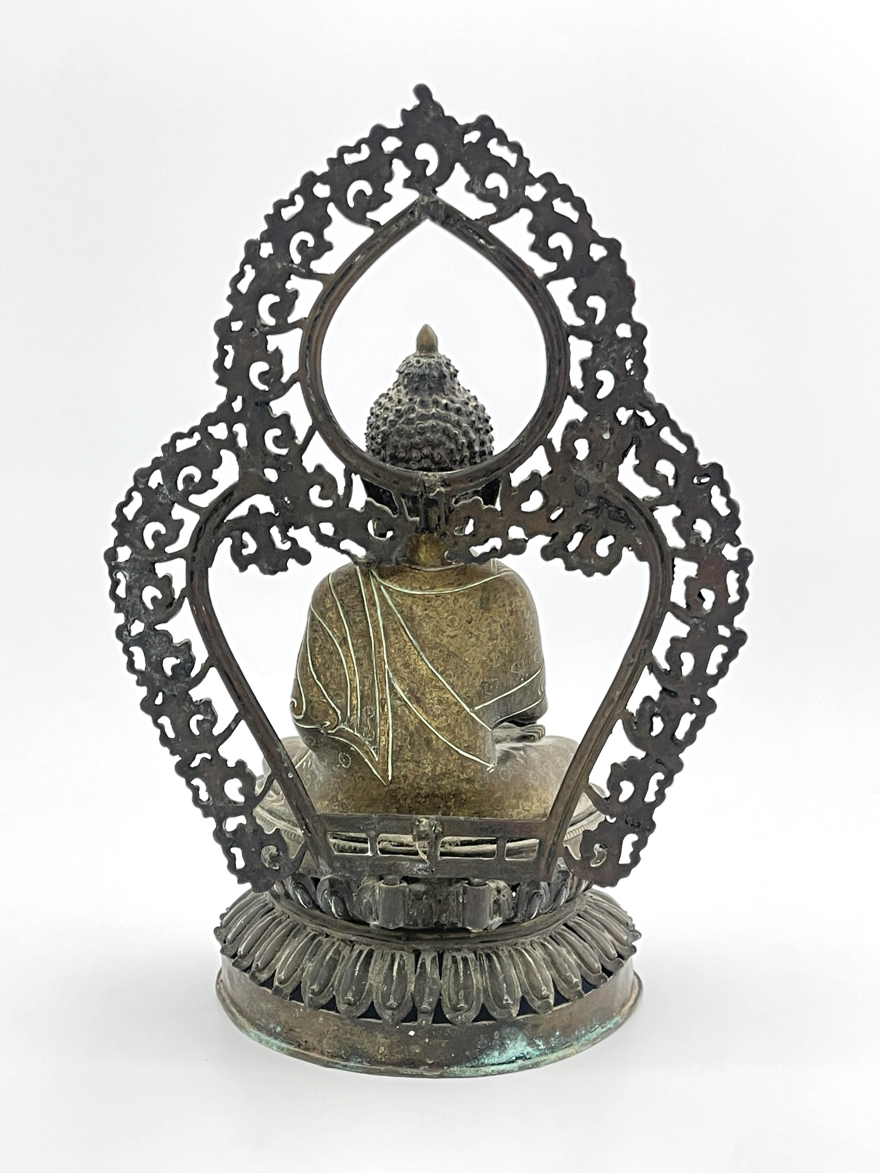 A Nepalese bronze figure of Guanyin, 19th Century, seated cross legged in front of an openwork, - Image 3 of 6