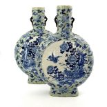 A large pair of Chinese relief moulded blue and white moonflask vases, Qing dynasty, incised four