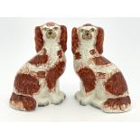 A pair of 19th Century Staffordshire flatback chimney dogs, modelled as brown and white spaniels,