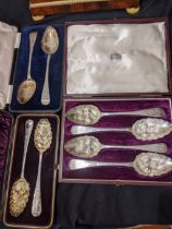 A cased set of four Georgian silver berry spoons, together with 2 cased pairs of Georgian silver