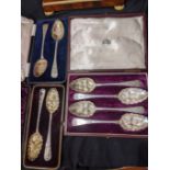 A cased set of four Georgian silver berry spoons, together with 2 cased pairs of Georgian silver