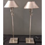 A pair of metal industrial style adjustable table lamps