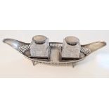 A Victorian silver inkwell, twin cut glass wells with silver collars and lids, hallmarked Chester,