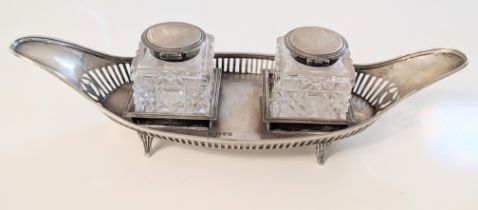 A Victorian silver inkwell, twin cut glass wells with silver collars and lids, hallmarked Chester,