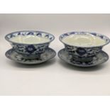 A pair of late 19th/early 20th century blue and white bowls and saucers, character marks to base,