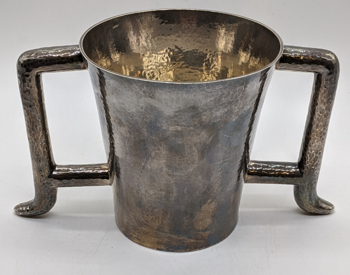 An Arts and Crafts Scottish silver twin handled cup, planished finish, hallmarked Edinburgh, 1897,