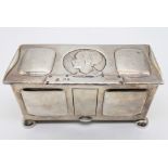 An Arts and Crafts silver box, designed by Kate Harris, the lid with embossed ladies head,