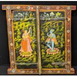 An Indian wooden window with double doors, depicting the Goddess Lakshmi