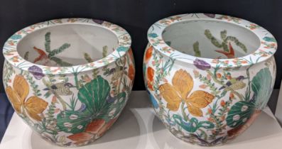 A near pair of large Chinese jardinieres, early 20th century, decorated with fish and floral designs