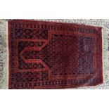 A small Persian or Turkish rug, blue and red field with a Greek key border, H.175 W.148cm,