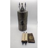 A miniature Torah scroll together with a miniature Tik scroll within a white metal case