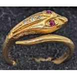 An 18ct gold snake ring, ruby eyes and 3 mounted diamonds, 3.3g