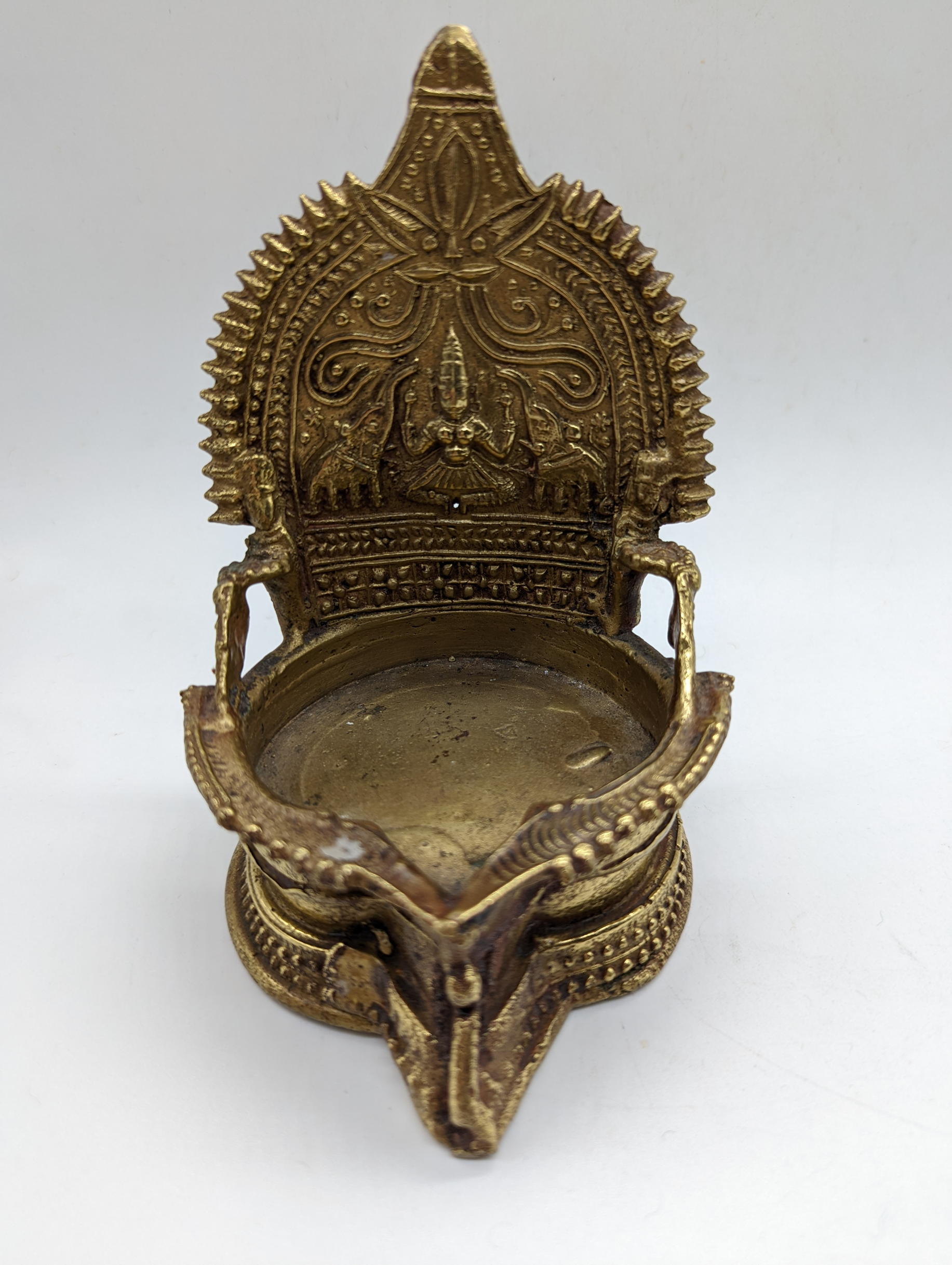 An Indian Brass Gajalakshmi Oil Lamp, with Hindu images of Goddess and Elephants, H.14cm