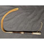 A 19th century Spanish Colonial quirt or whip, woven leather handle, silver covered top, South