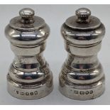 A pair of 20th century silver salt and pepper mills, London hallmarks, H.8cm