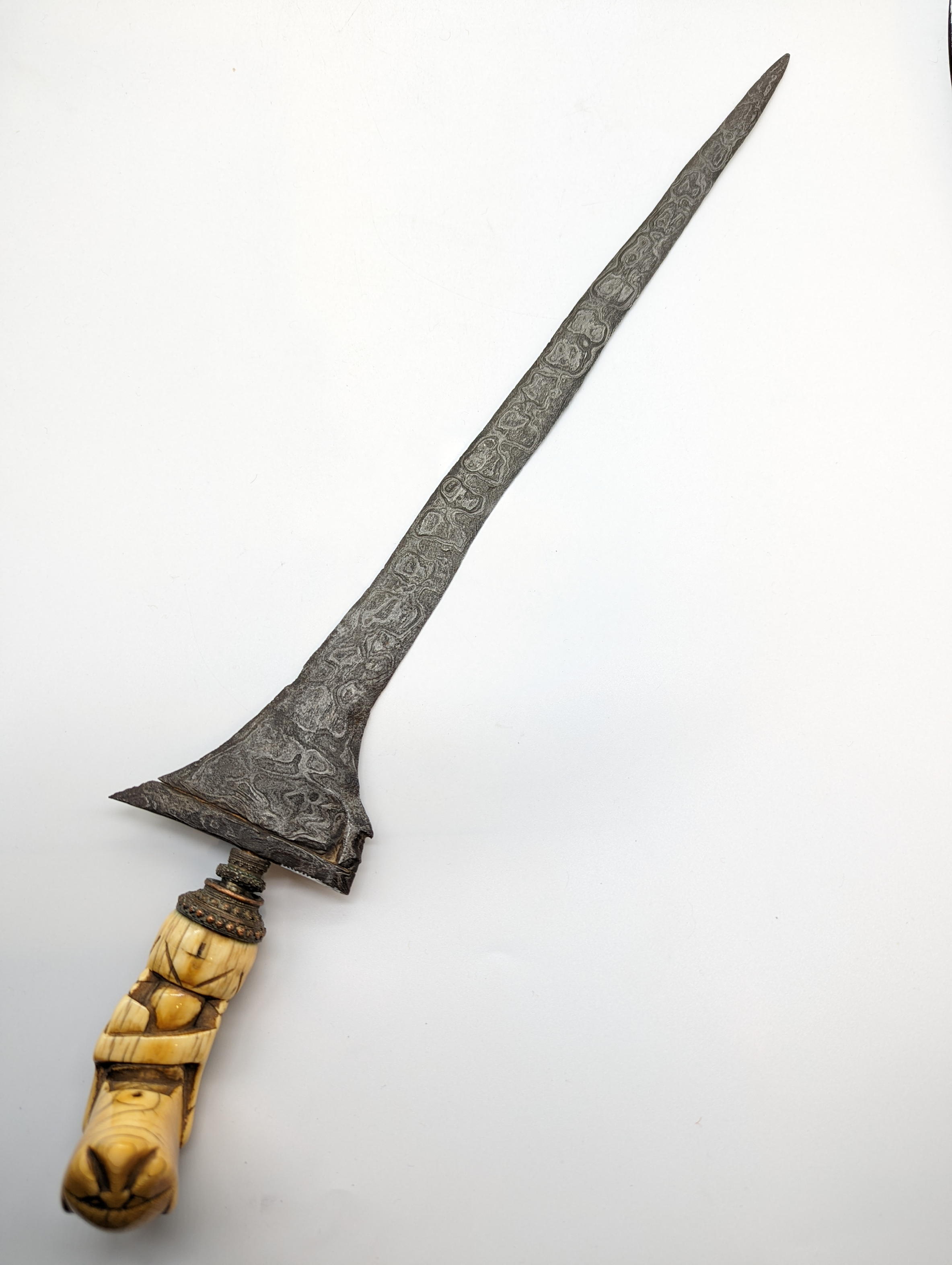 A 16th century Kris Perkaka dagger, iron layered pamour blade, ivory hilt with nickel, Northern