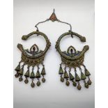 A pair of Moroccan Berber silver headdresses, enamelled with ornaments and chains