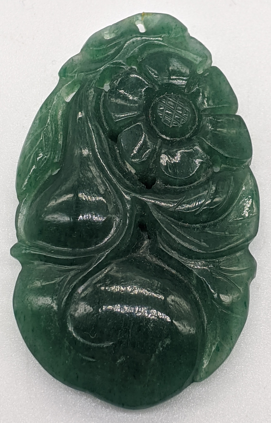A Chinese green jade carving of flowers and fruit, L.5.5cm