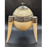 A late 19th century Indian ostrich egg tea caddy, walrus ivory legs with silver mounts and eagle