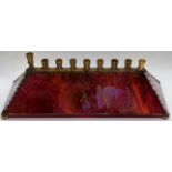 Leona Fein (American, b.1930), a stained glass menorah, signed, H.8.5cm L.29.5cm