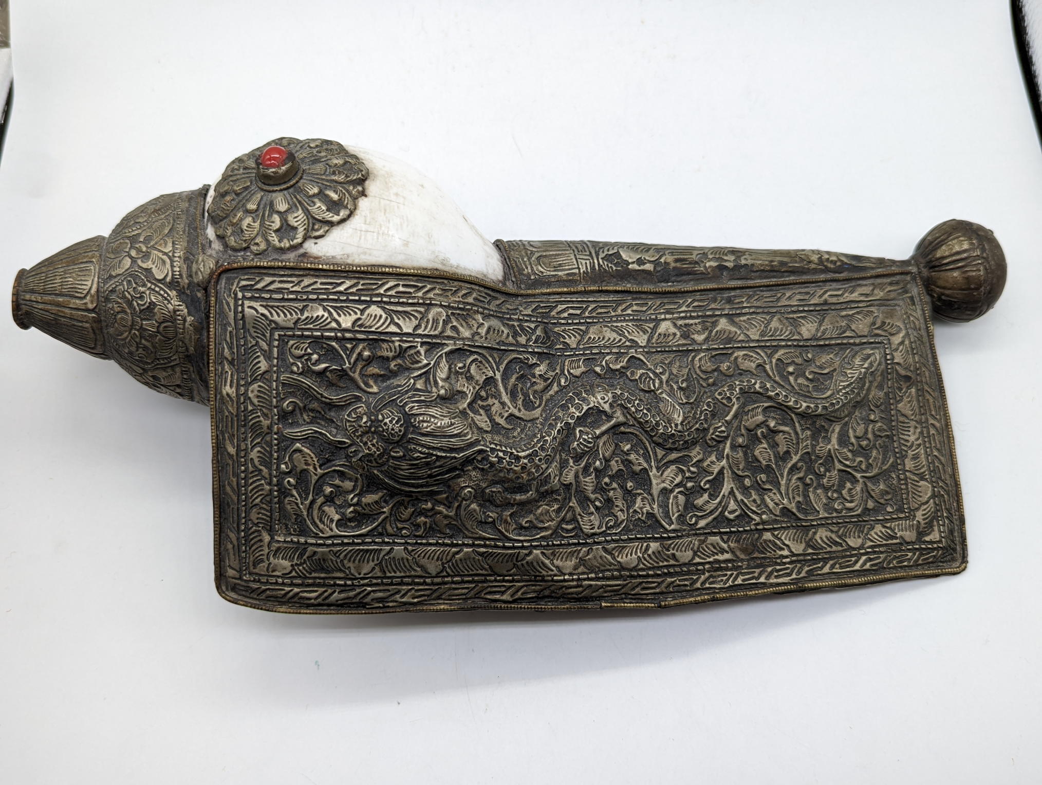 A Tibetan or Nepalese Buddhist Conch Shell Ceremonial Trumpet with White Metal Mount decorated