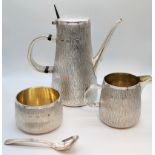 A Gerald Benney silver tea set, comprising of a teapot, milk jug, sugar bowl and spoon, bark