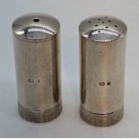 A pair of Stuart Devlin silver shotgun cartridge style salt and pepper, textured bands, hallmarked