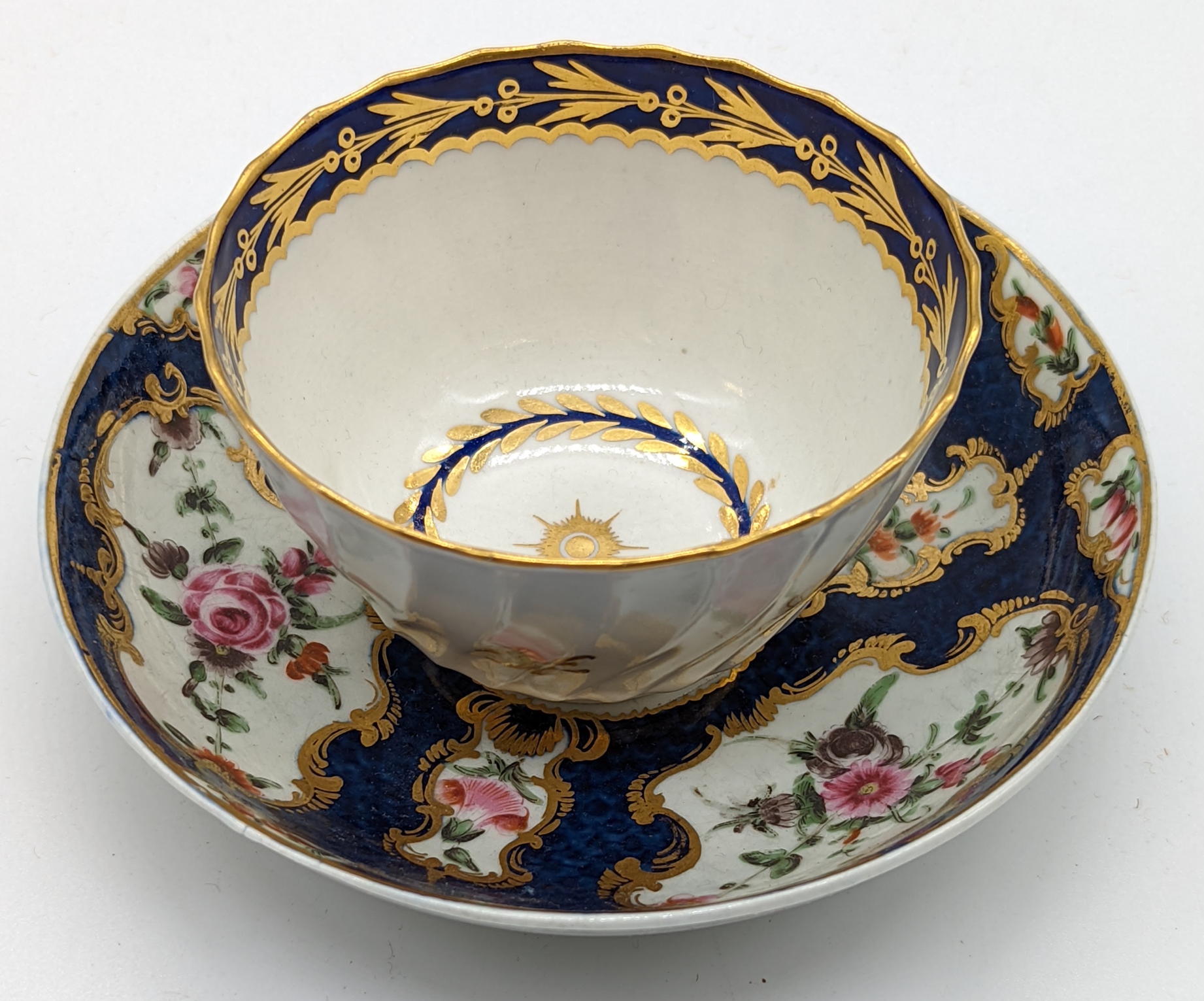 An 18th century Worcester cup and saucer, navy moon to base of both pieces