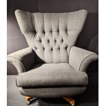 An Orbit 20th century button back swivel chair, grey upholstery, raised on X-stretcher and