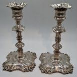 A pair of George III silver candlesticks, indistinct marks to base, 1055g, H.18.5cm