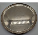 An early 20th century silver salver, raised on 3 feet, hallmarked London, 1925, engraved, 1128g, D.