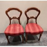 A pair of Victorian Mahogany dining chairs, red striped upholstery