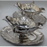 A pair of 19th century French silver sauceboats on trays, marks to edge, 1390g, L.25.5cm