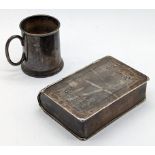 A silver box in the form of a book, L.11.5cm, seemingly unmarked, together with a silver mug, London