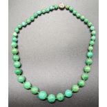 A Chinese green jade bead necklace