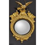 A Regency giltwood convex wall mirror, eagle finial, H.102cm