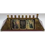 Leona Fein (American, b.1930), a stained glass menorah, signed, H.8.5cm L.29.5cm