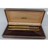 A Dunhill gold plated fountain pen and ball point pen set