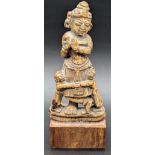 A 15th or 16th century South Indian carved bone figure of Krishna playing the flute, raised on